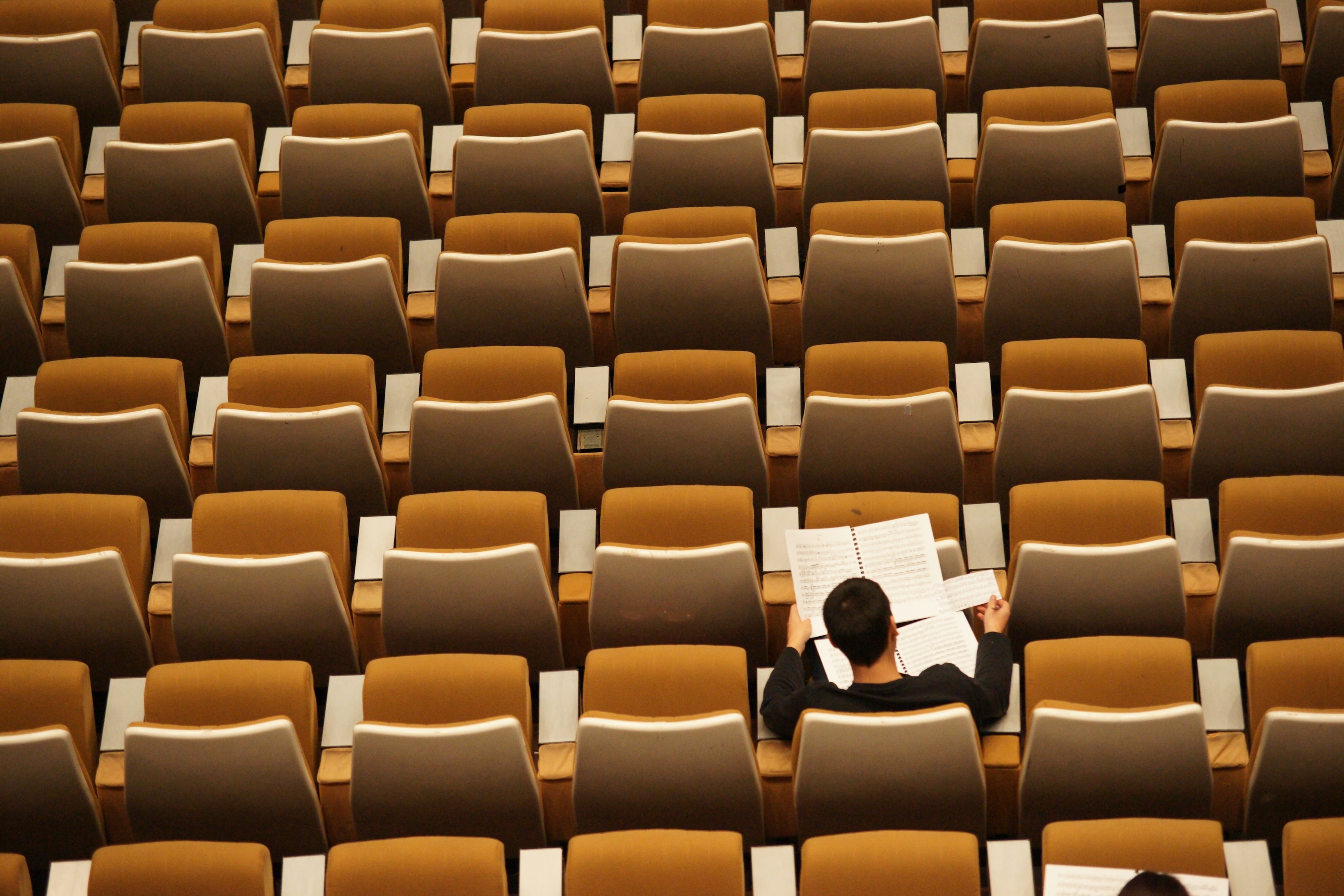 Man sitting in empty auditorium