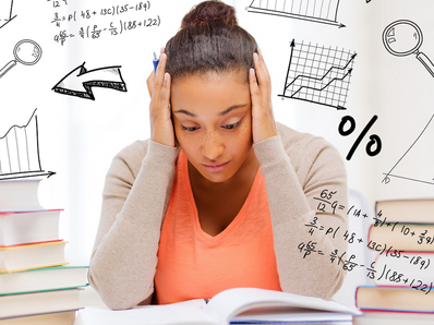 Young student stressed by her examinations in a classroom