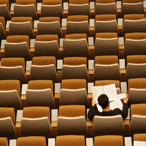 Man sitting in empty auditorium
